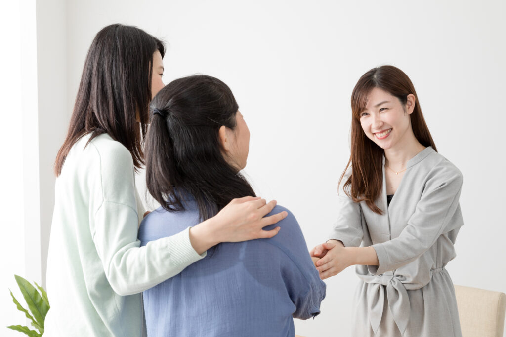 Marketing representative shaking hands with customers during face-to-face marketing.