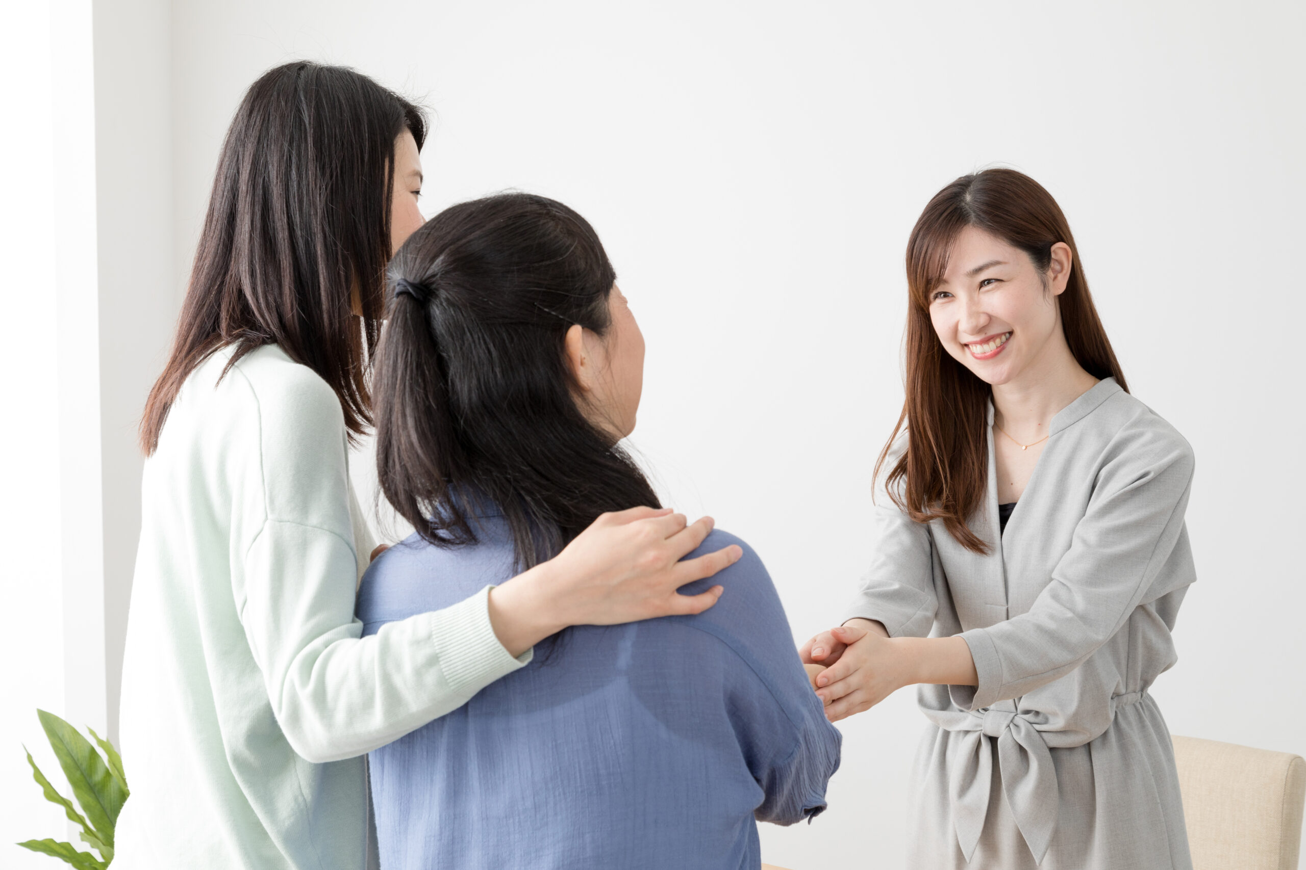 Marketing representative shaking hands with customers during face-to-face marketing.