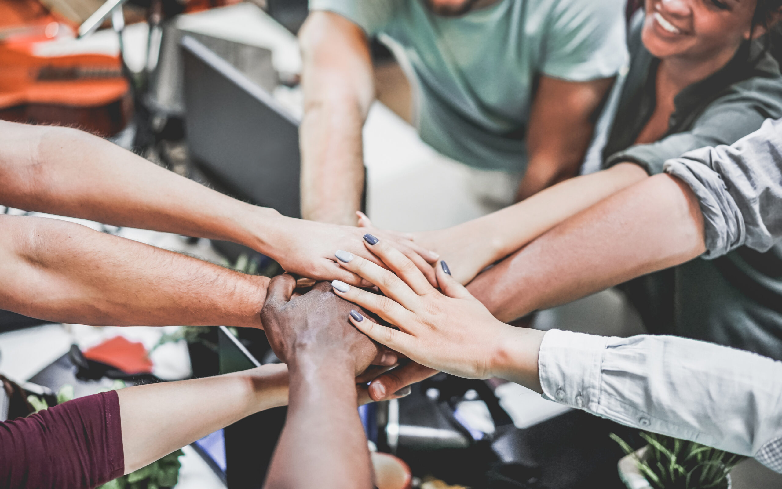 Team members stacking their hands, representing team motivation.